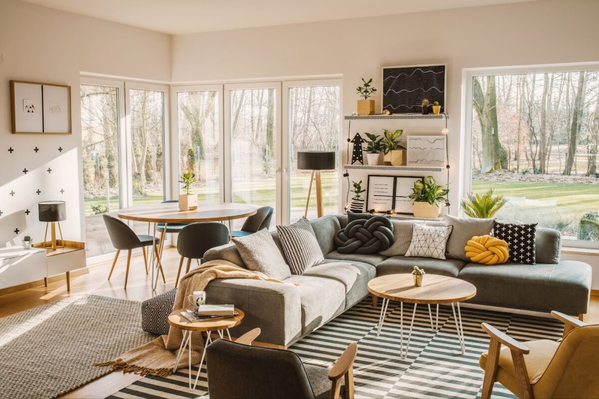 Bright and modern living room with large windows, captured using natural light for a real estate listing